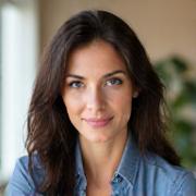 Professional headshot of Dr. Elena Petrova, a compassionate female clinical psychologist in her late 30s-early 40s, with a reassuring expression, against a clean, modern background.